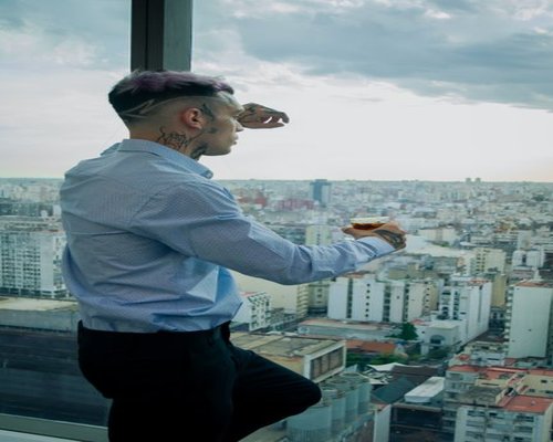 A person looking out the window of a high-rise office building in Mexico City